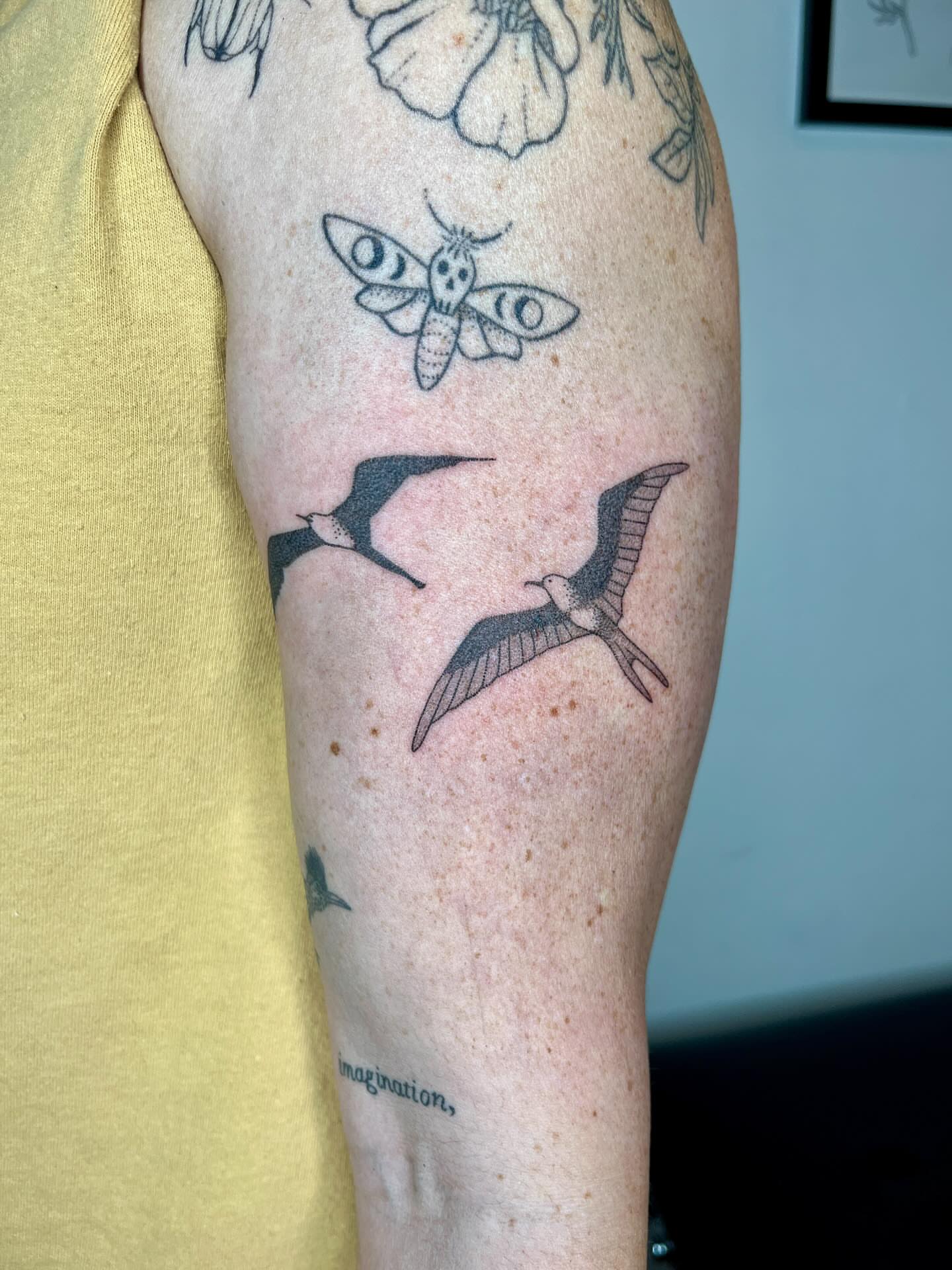 Birds and moth black and grey tattoo on the forearm by natalie
