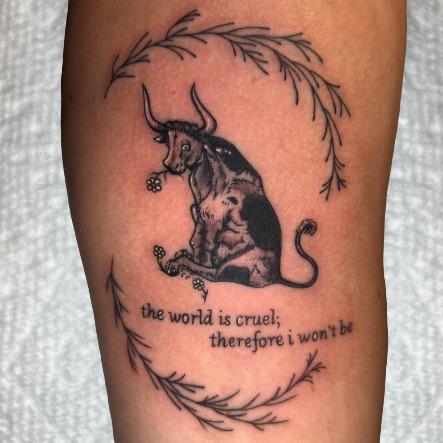 Bull and flower black and grey tattoo on the forearm by Ashley Lambert
