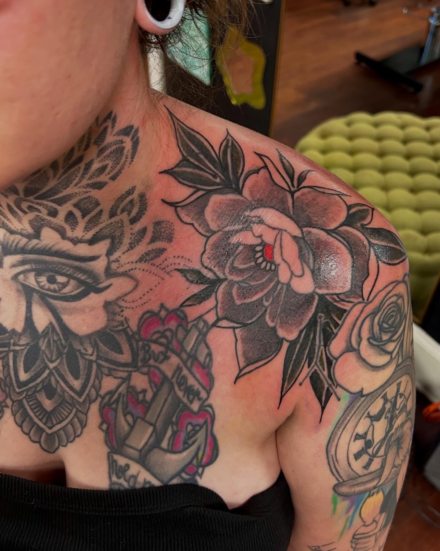 Floral and eye American traditional tattoo on the shoulder by Jon Byrd
