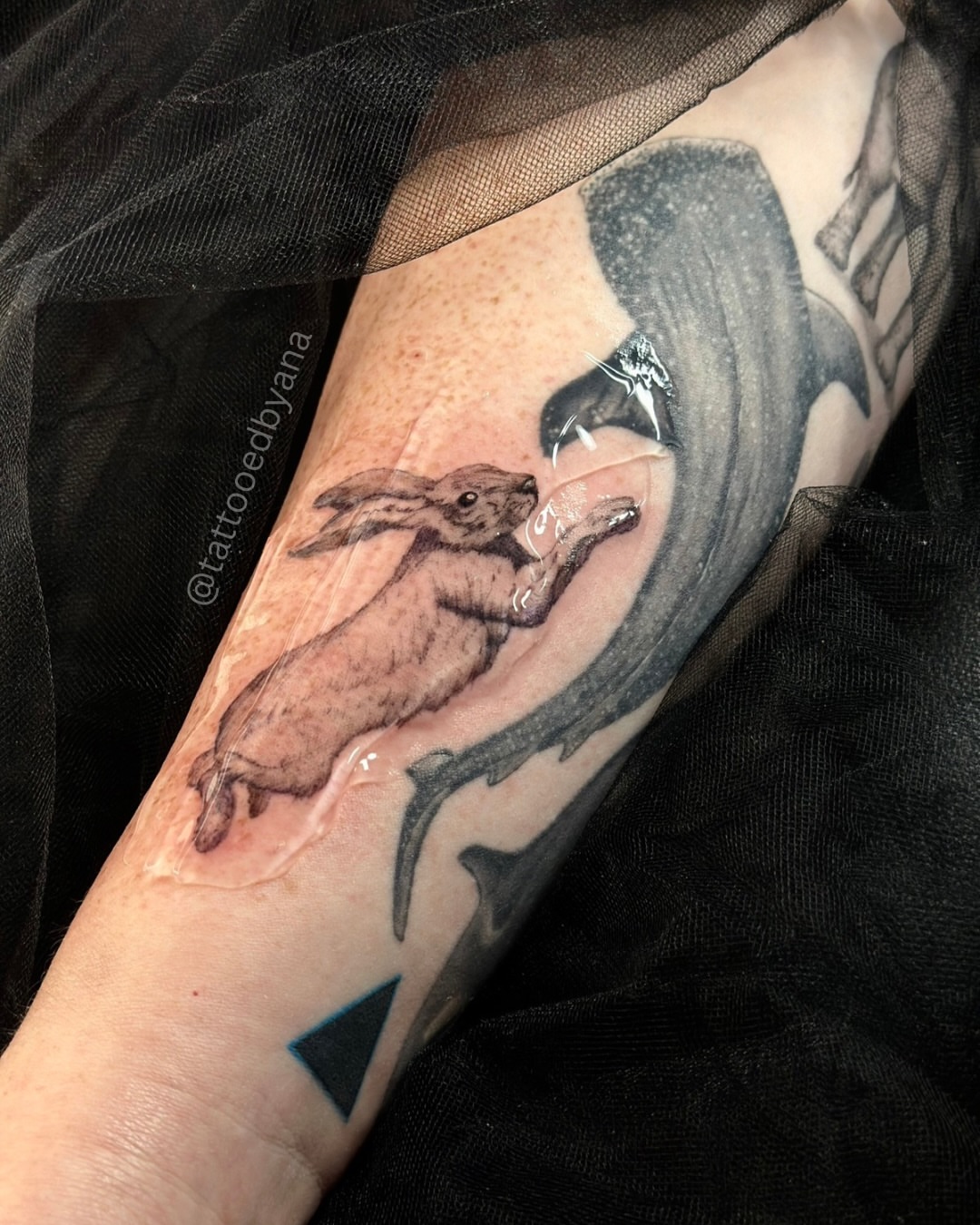 Hare and whale black and grey tattoo on the forearm by Tattoo artist Denver