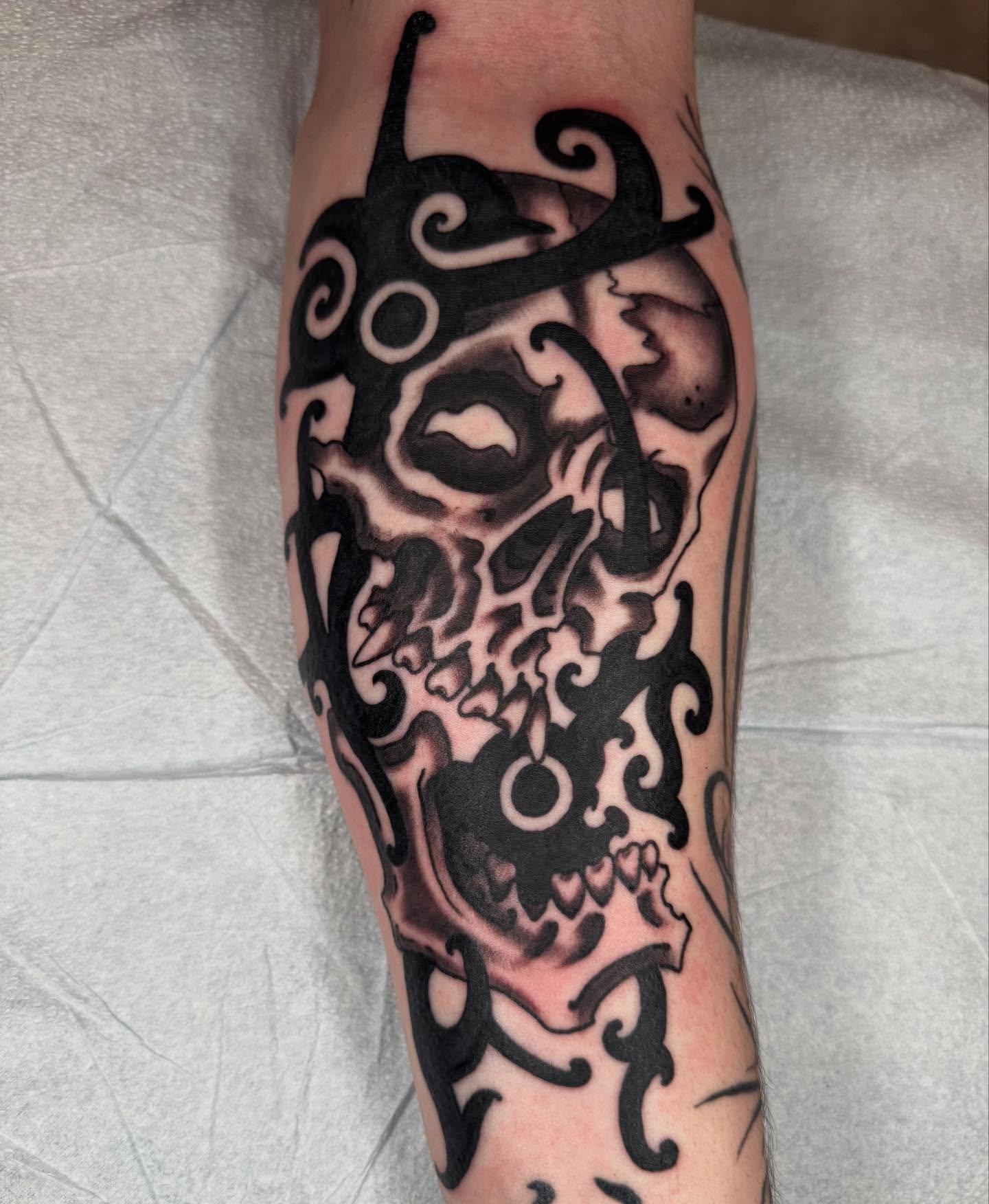 Skull tribal tattoo on the forearm by Noah Moretz