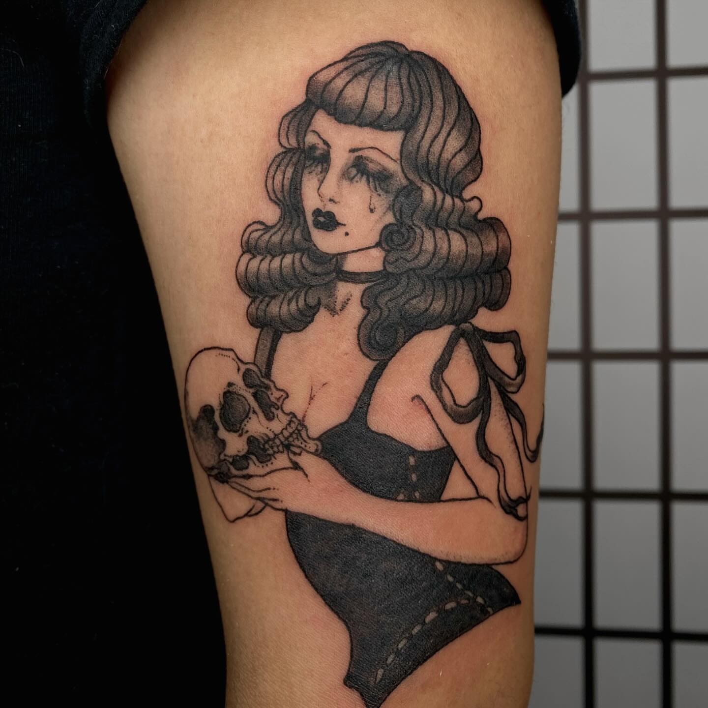 Woman with skull American traditional tattoo on the thigh by sarah 🗝️