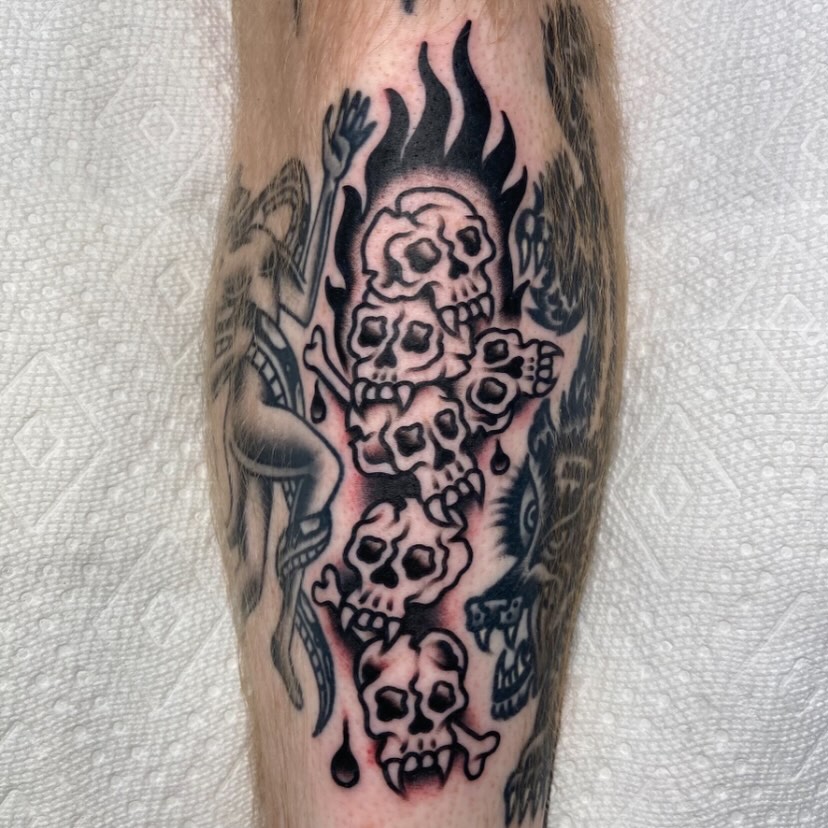 Skulls and flames black and grey tattoo on the forearm by Anthony Jaeger, Seattle, Washington