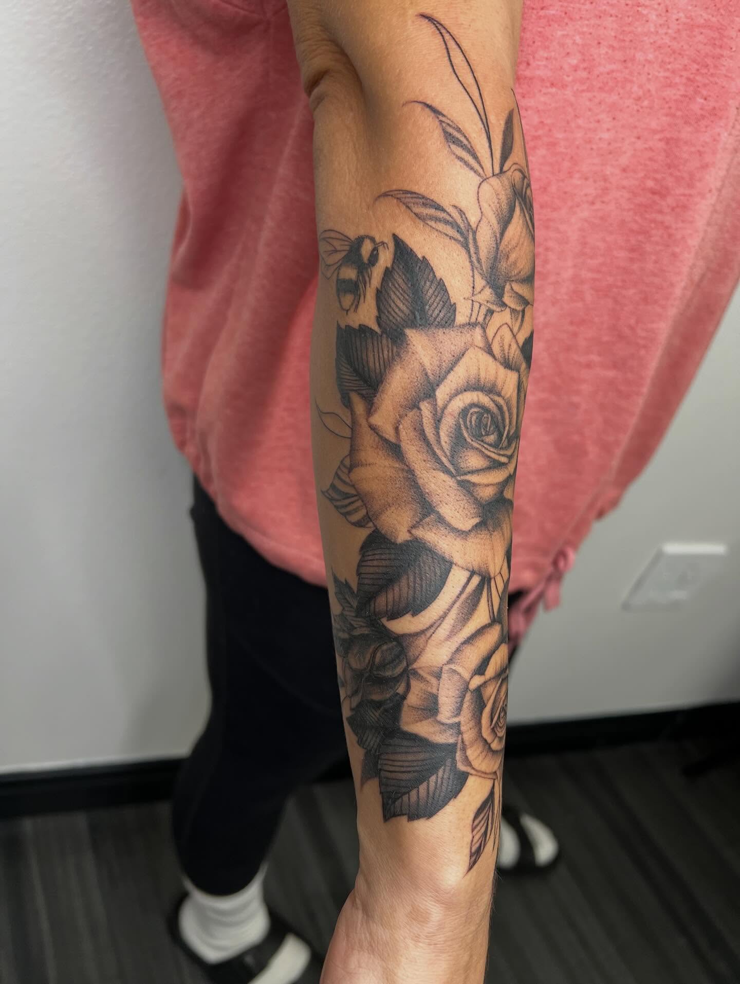 Roses and bee realism tattoo on the forearm by San Diego Fineline Black & Grey Tattoo Artist