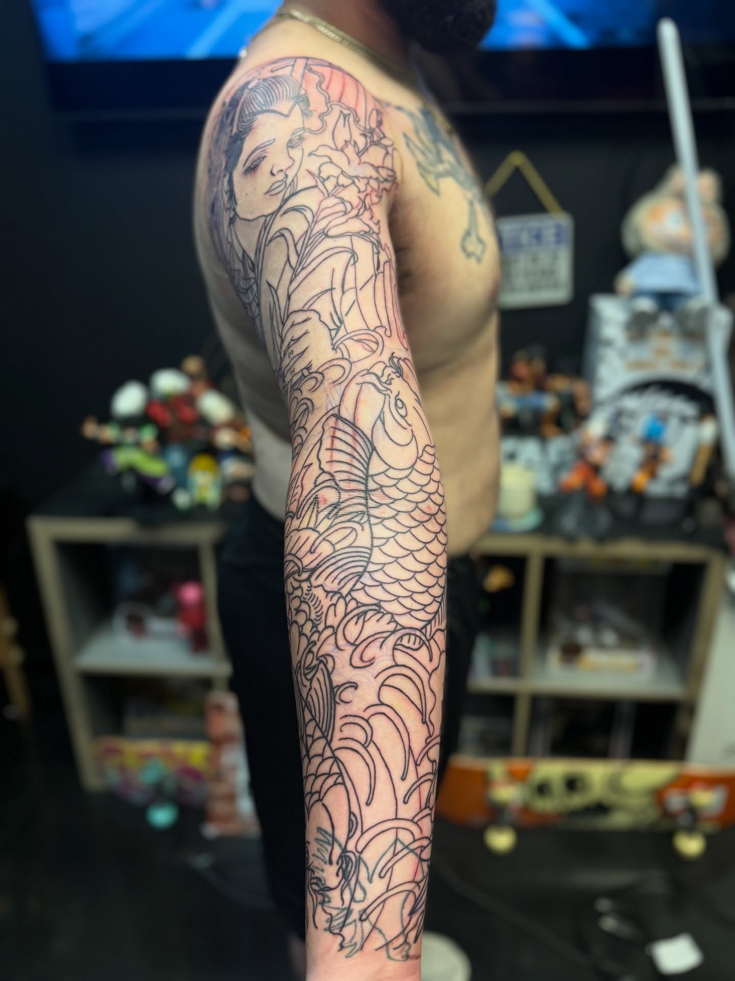 Woman with fish japanese irezumi tattoo on the forearm by Zack Yang, Houston, Texas