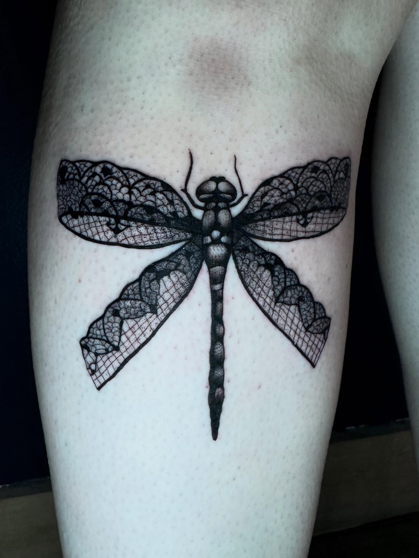 Dragonfly black and grey tattoo on the thigh by Morgan Peeples