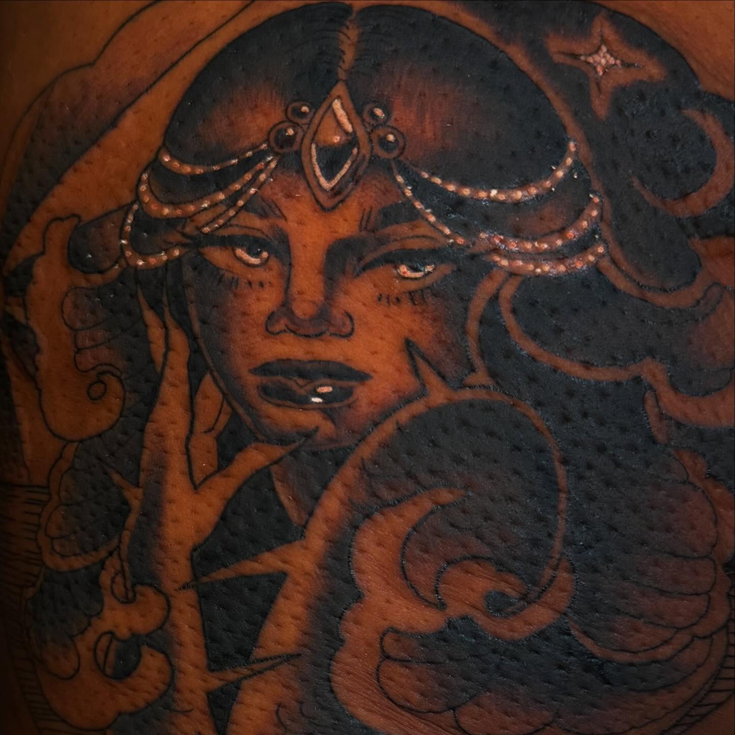 Woman with headdress black and grey tattoo on the upper arm by Reagan Mauldin
