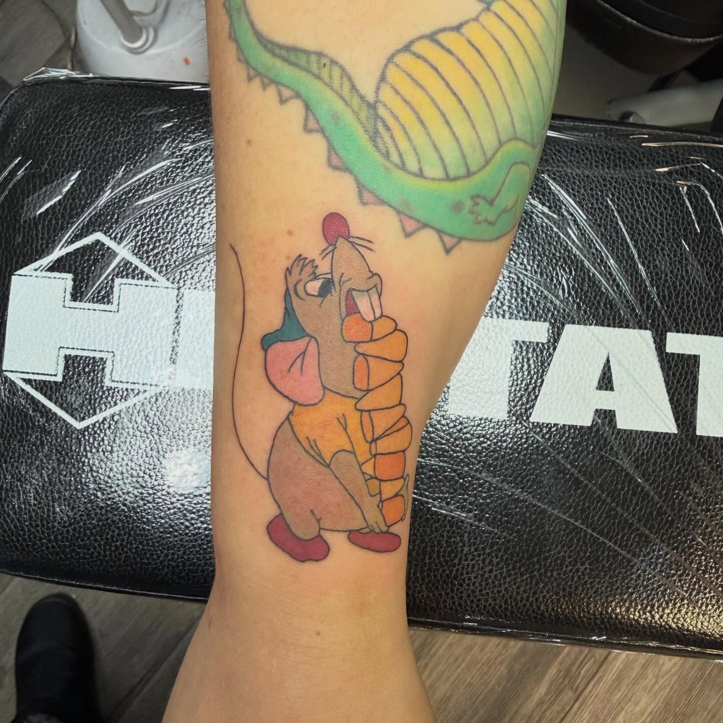 Donkey eating ice cream watercolor tattoo on the forearm by Elena