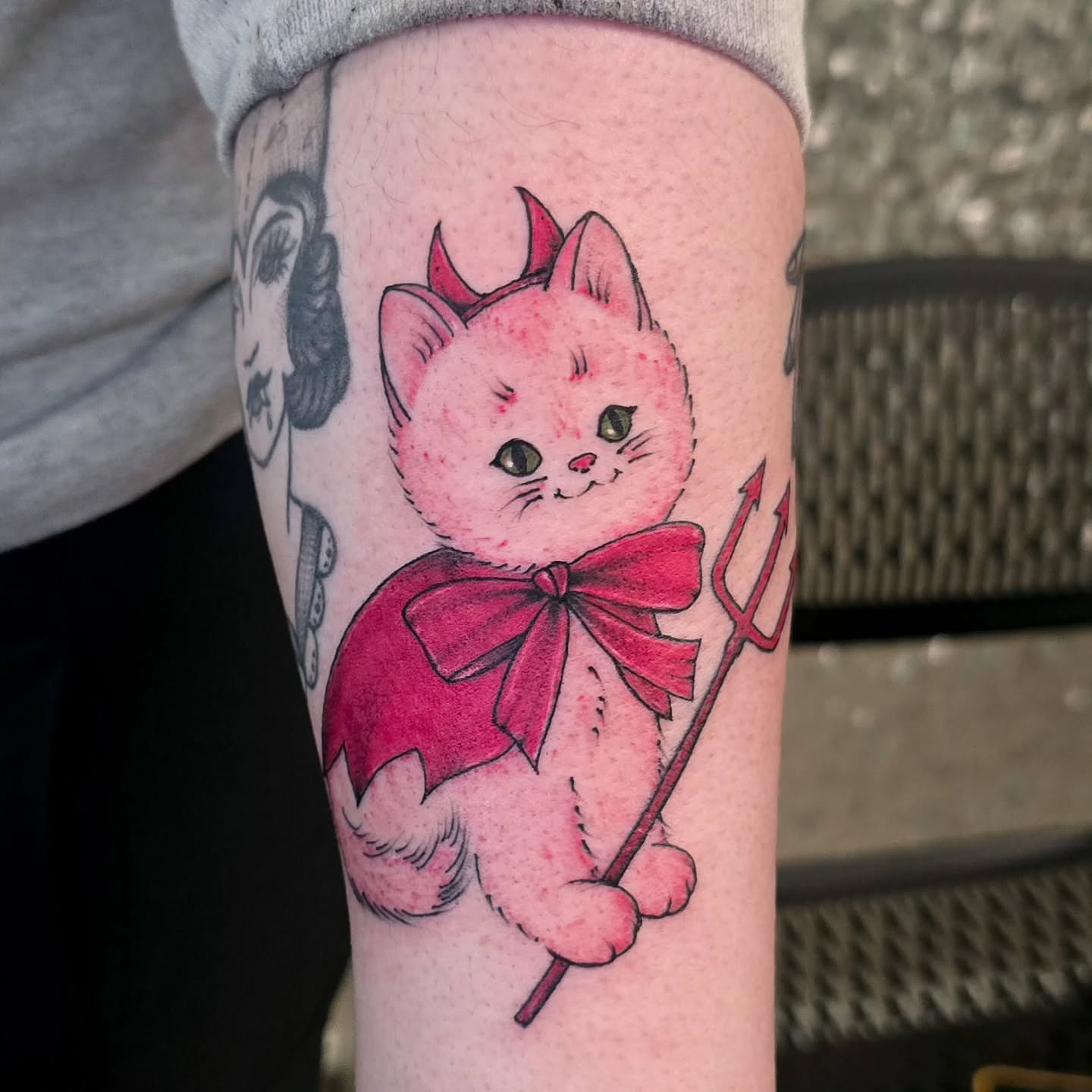 Cat with devil horns new school tattoo on the forearm by Hope 🌙, Cincinnati