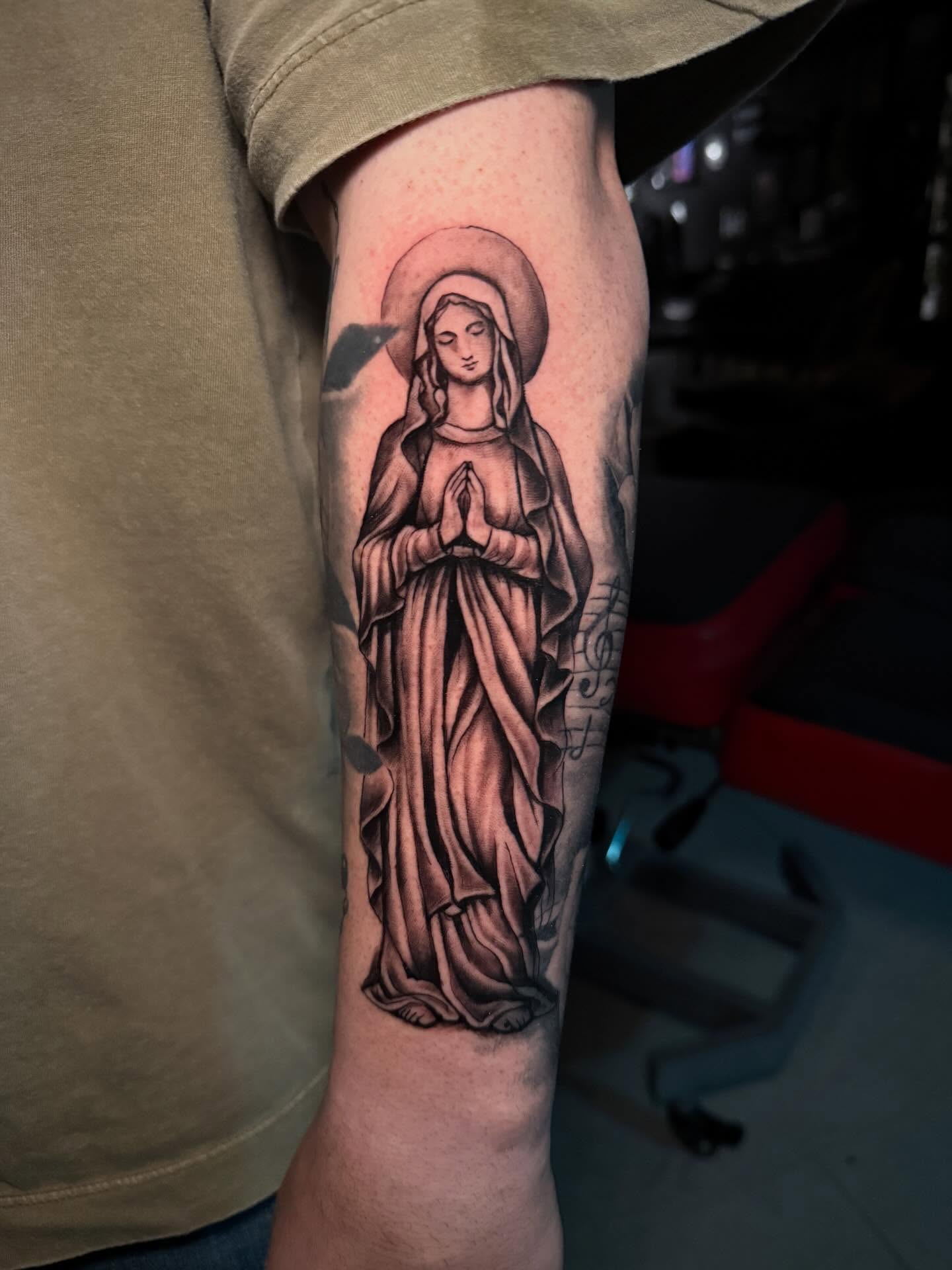 Religious figure black and grey tattoo on the forearm by Lucky Valenzuela, Lakewood, Colorado
