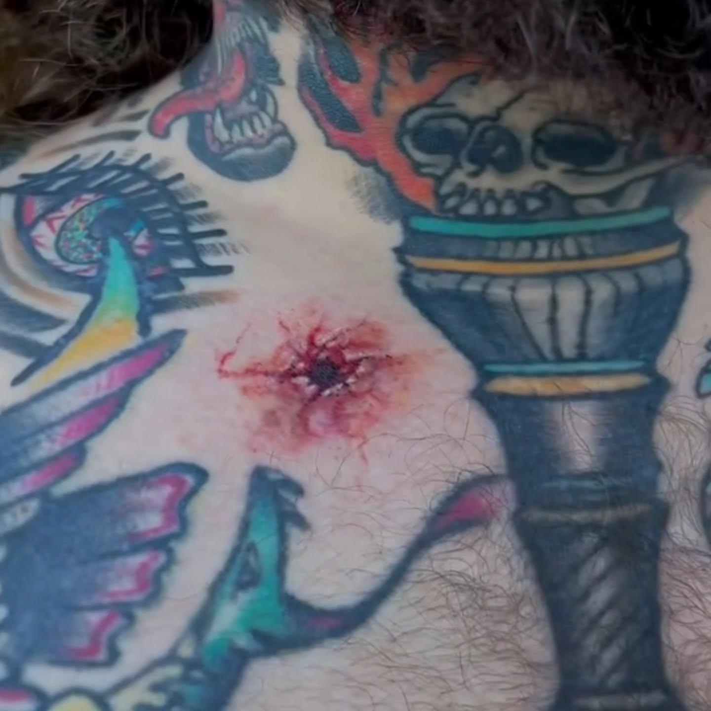 Skull and flame American traditional tattoo on the chest by SJ Horvath