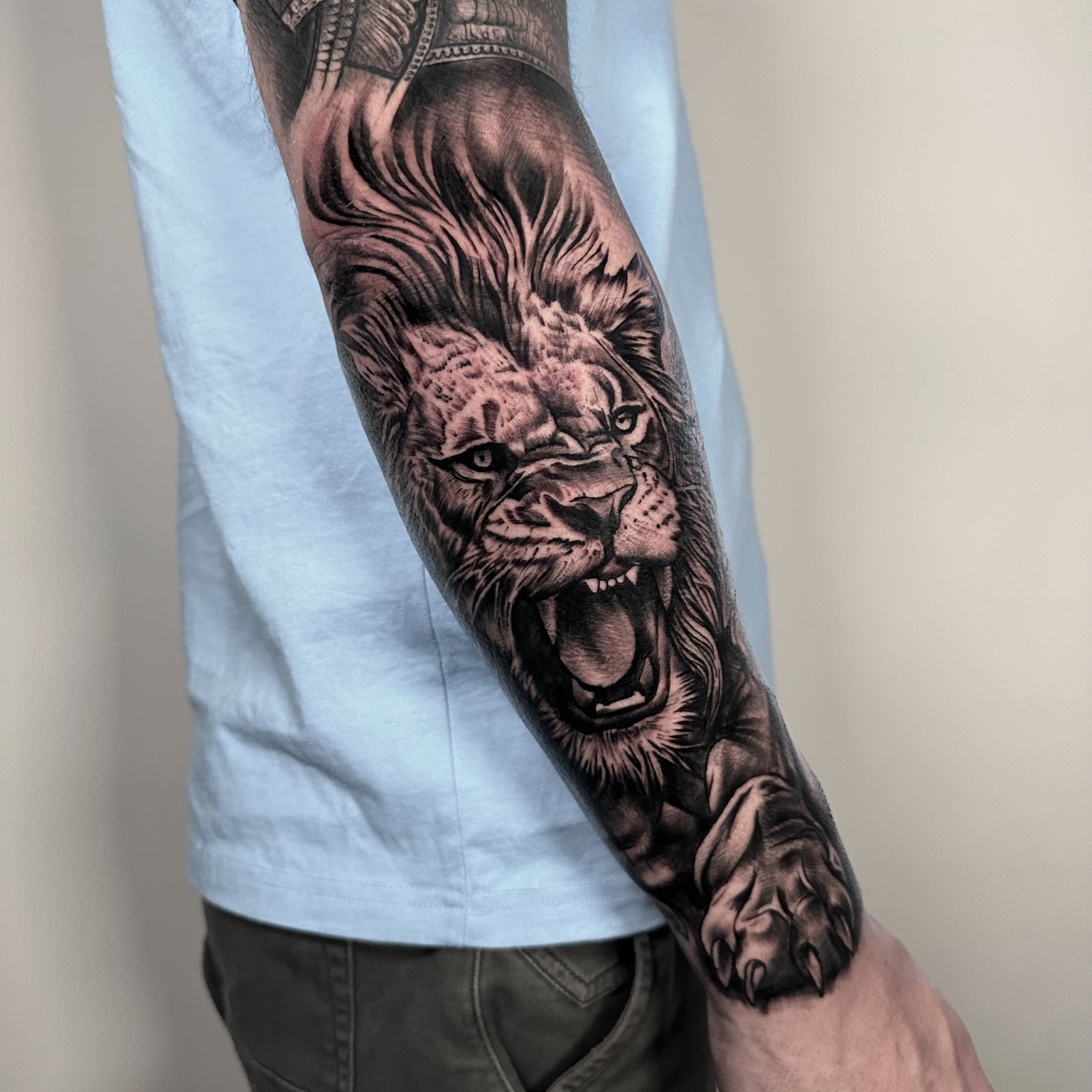Roaring lion realism tattoo on the forearm by Tattoos By Josh