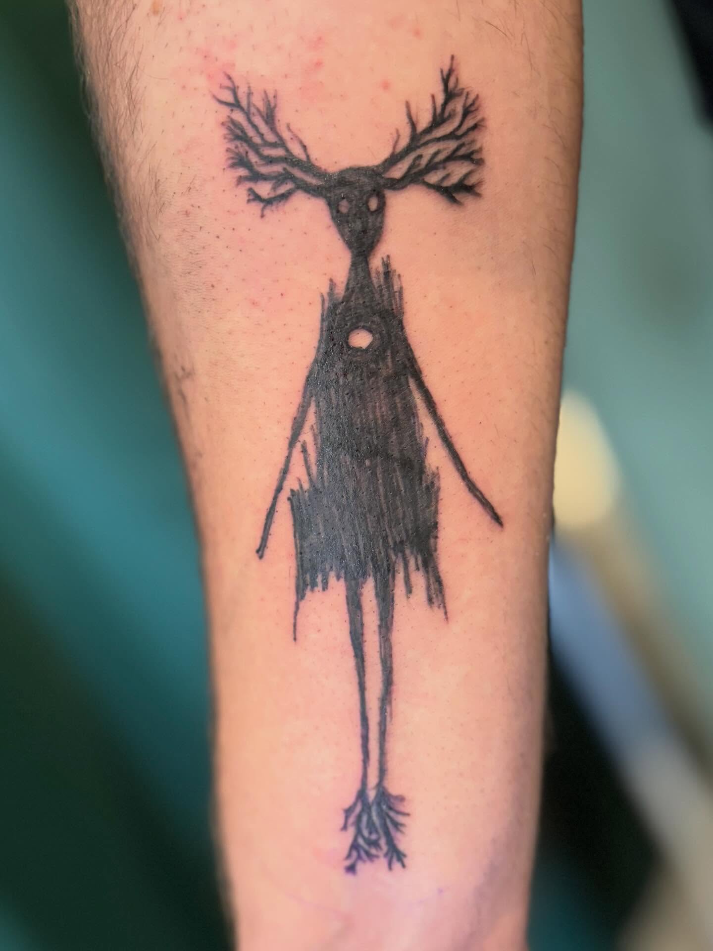 Deer-like creature black and grey tattoo on the forearm by Runtz Tattoo, Greensboro, North Carolina