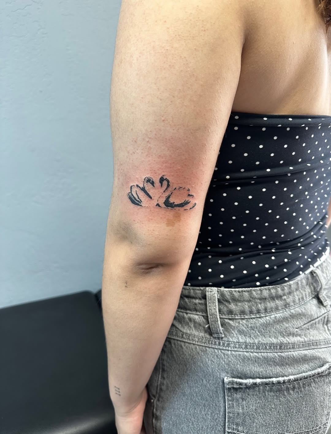 Two swans fine line tattoo on the forearm by Lupita Ink
