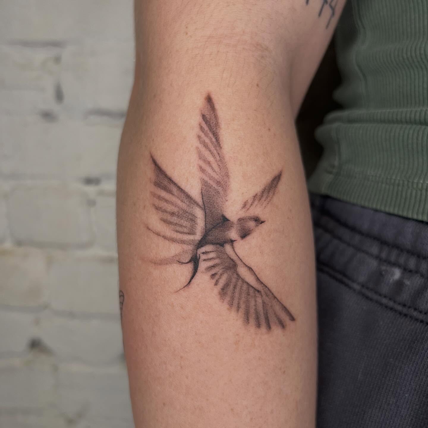 Two birds black and grey tattoo on the forearm by Robb Wilson