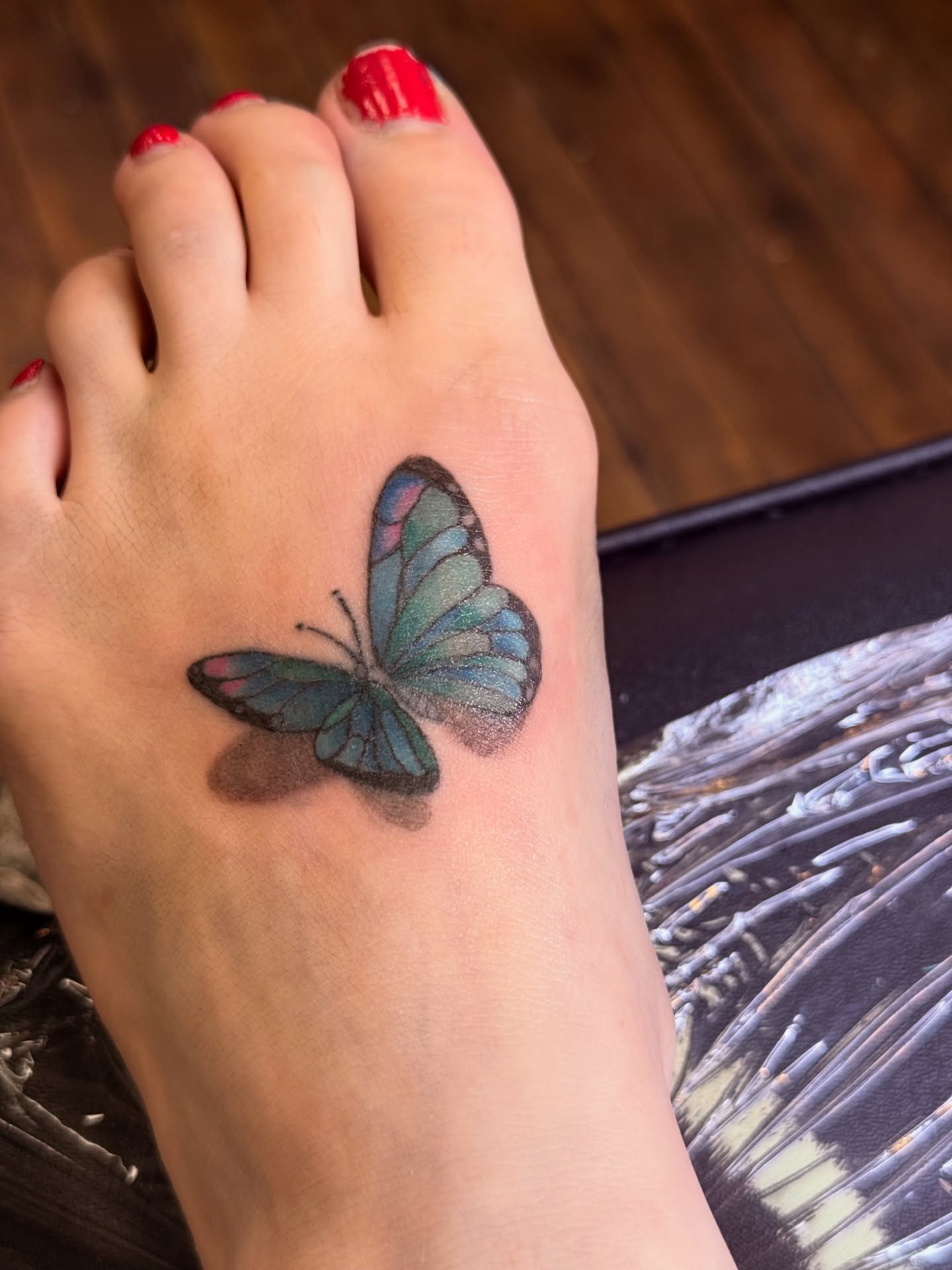 Butterfly realism tattoo on the foot by Whimsy Ink