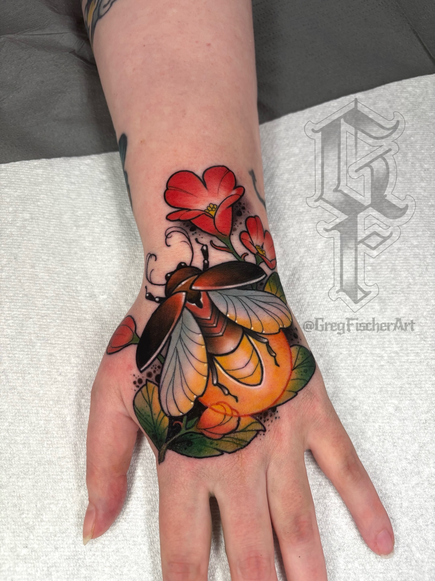 Beetle and flowers American traditional tattoo on the hand by Greg Fischer