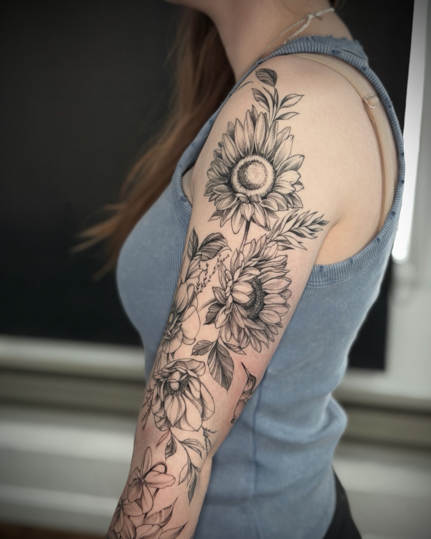 Sunflowers black and grey tattoo on the upper arm by R e N O T