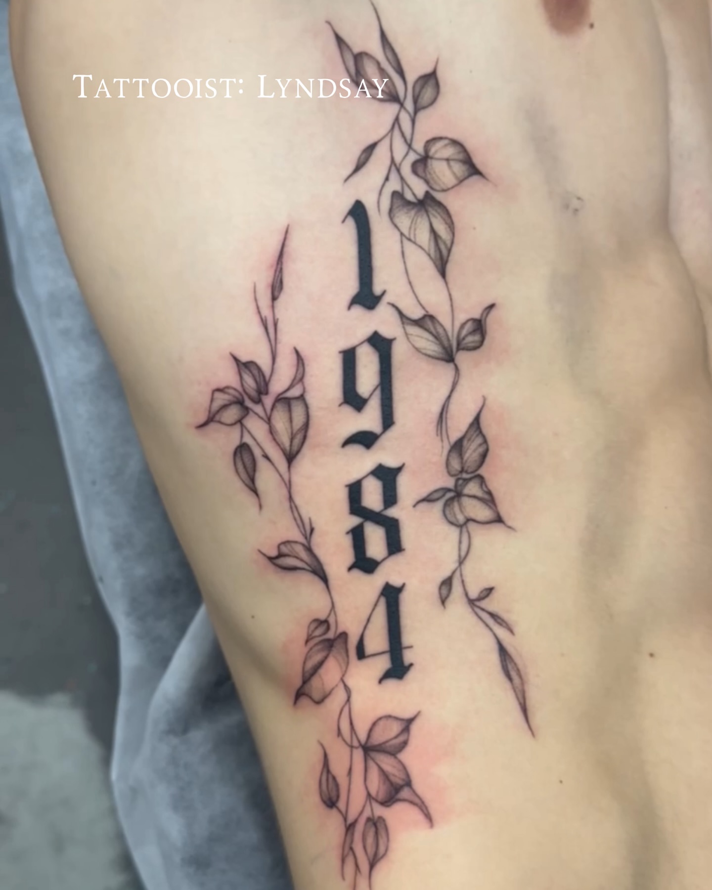 1984 black and grey tattoo on the thigh by Lyndsay Southgate
