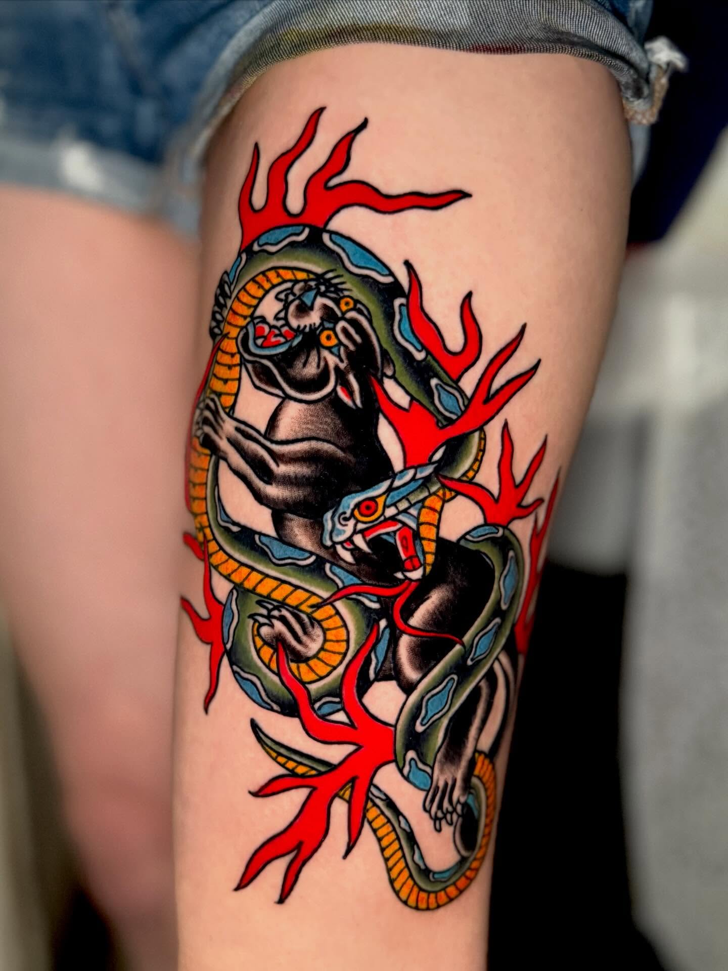 Snake and flame American traditional tattoo on the thigh by Seth Walker