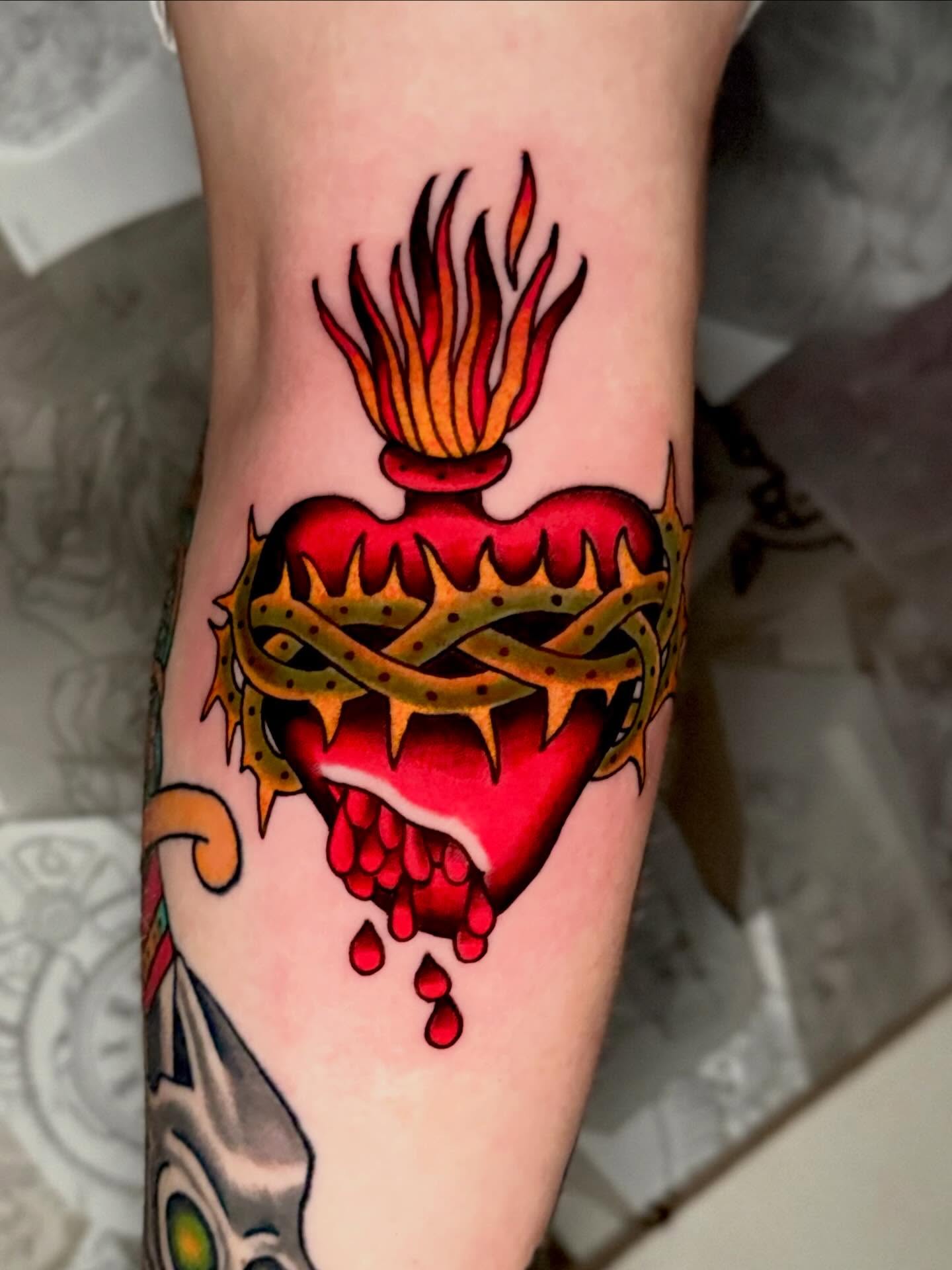 Burning heart American traditional tattoo on the forearm by Seth Walker