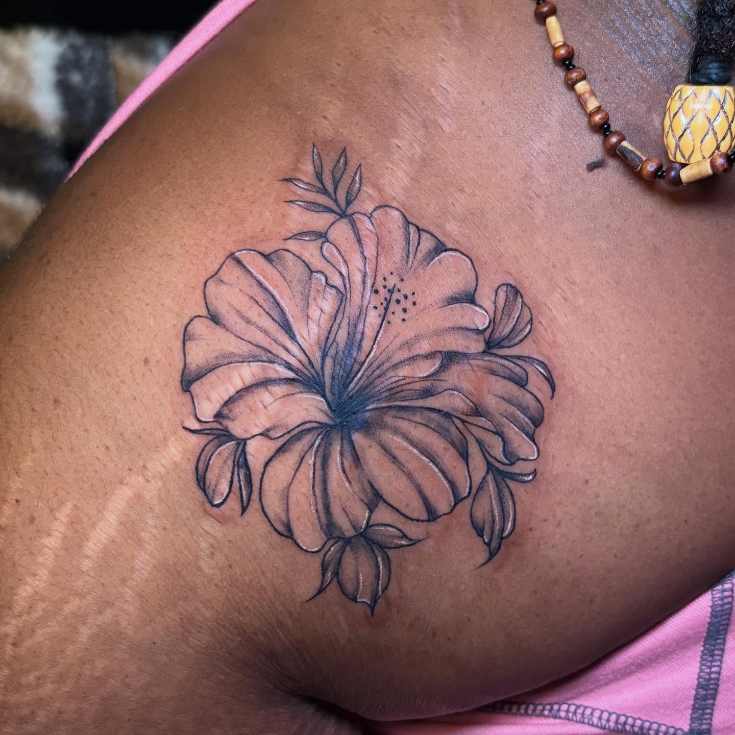 Hibiscus flower black and grey tattoo on the thigh by 𝕶𝕬𝕿