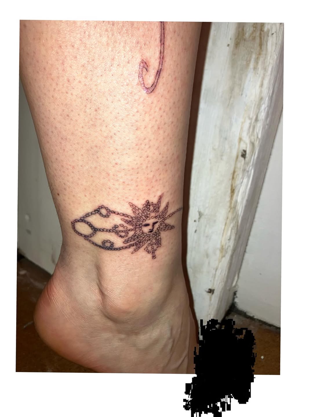 Sun with chains blackwork tattoo on the calf by Sashka