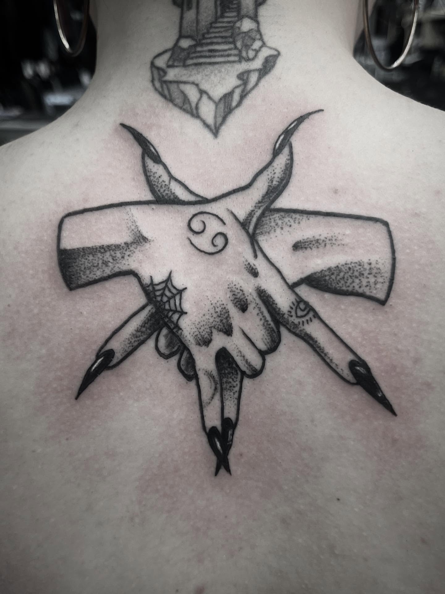 Cross with horns dotwork tattoo on the back by Sean Gallagher
