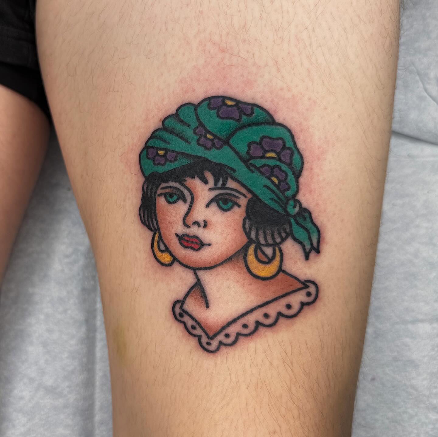 Woman wearing hat new school tattoo on the thigh by 𝕮𝖆𝖘𝖊𝖞 𝕭𝖆𝖘𝖍𝖊𝖗
