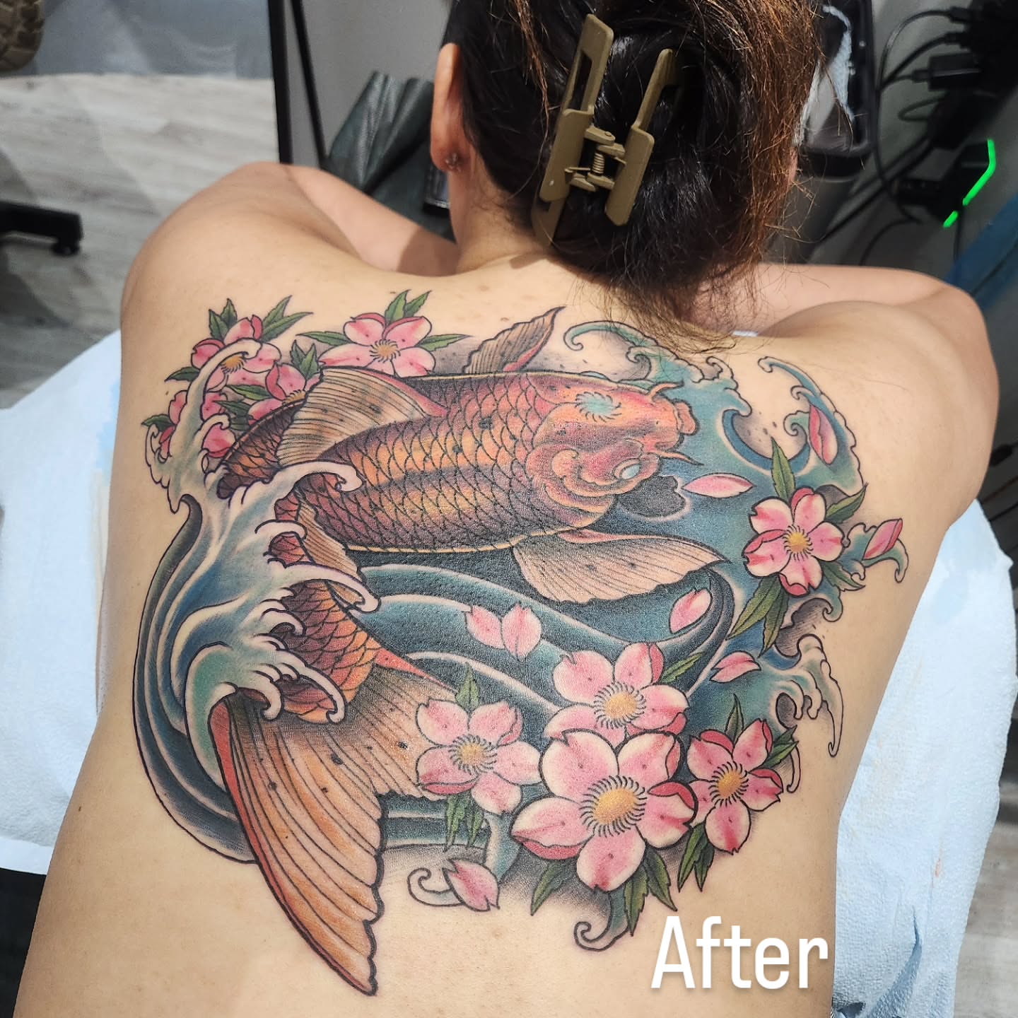 Koi fish and cherry blossoms japanese irezumi tattoo on the back by Chris Bowen