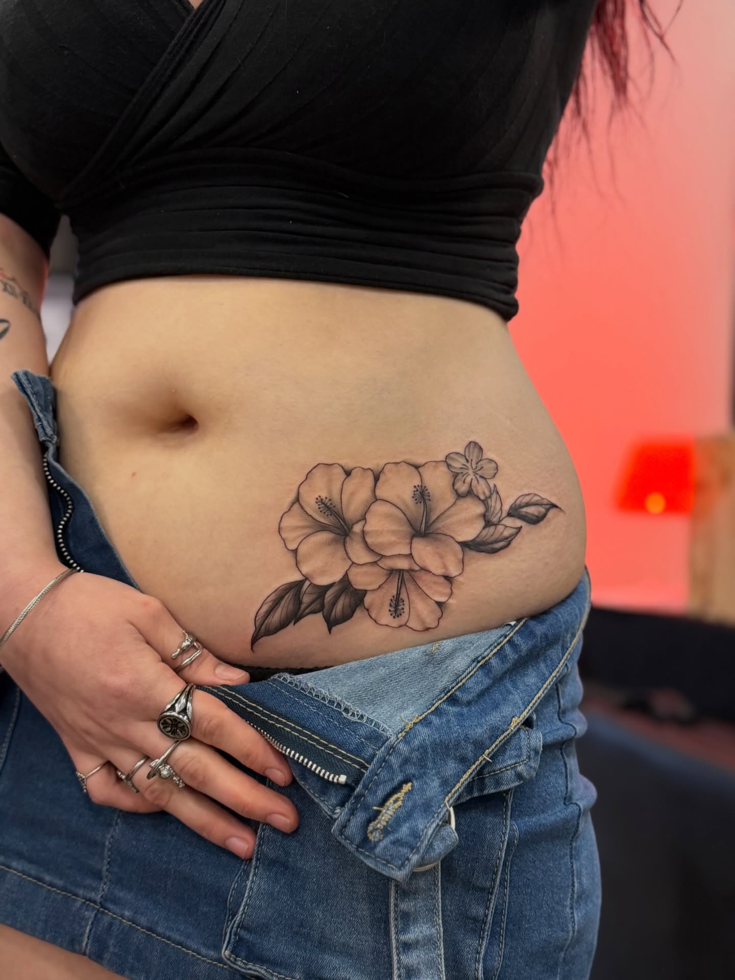 Hibiscus flowers black and grey tattoo on the torso by North County Sd