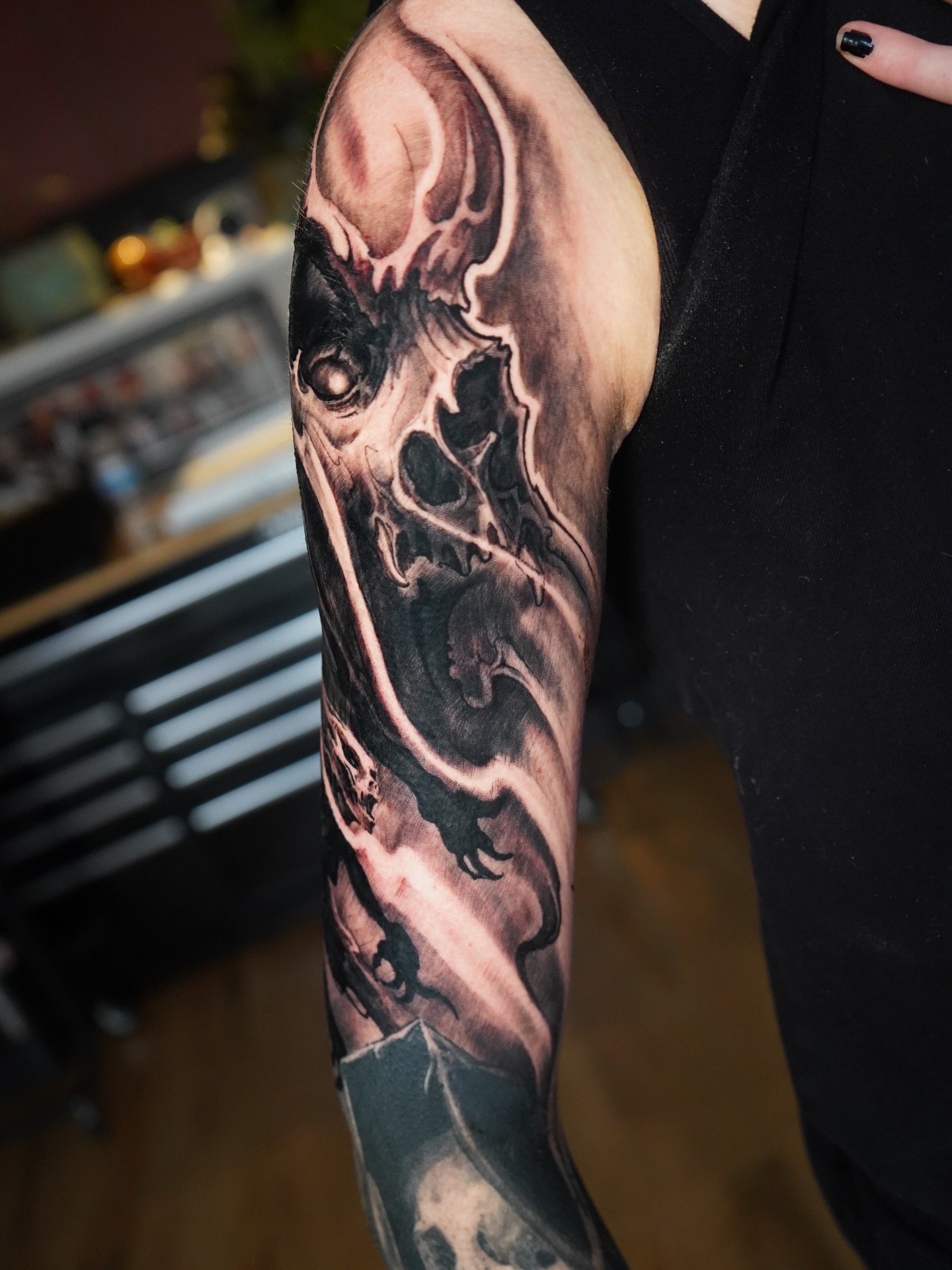 Abstract skull dark realism tattoo on the forearm by Darl Gnau