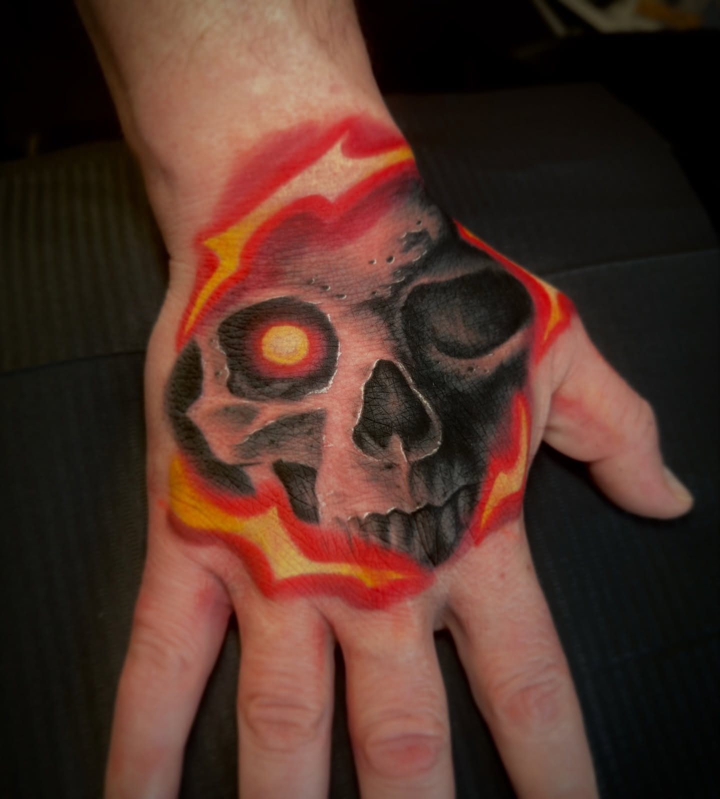 Flaming skull realism tattoo on the hand by Luke Mullins, Frederick, Maryland
