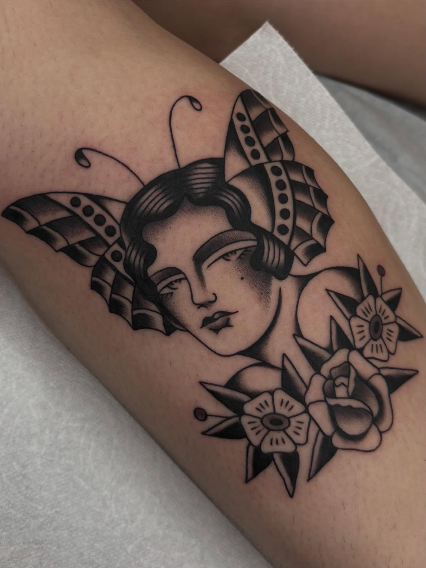 Woman with flowers American traditional tattoo on the thigh by Claire Anderson