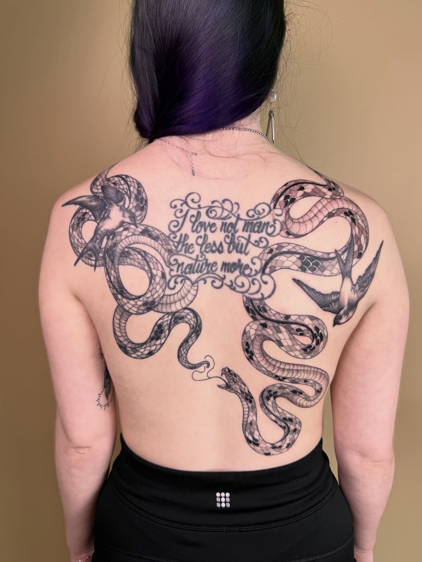 Snakes and script black and grey tattoo on the back by Jena Perry
