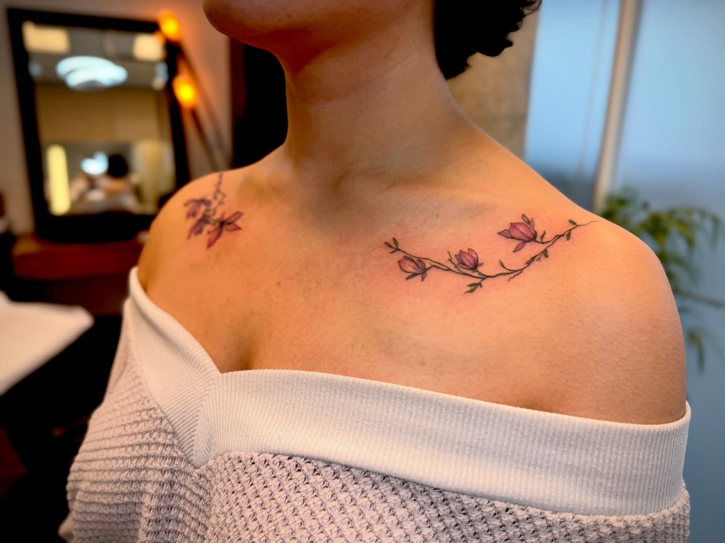 Flower vine fine line tattoo on the shoulder by Aristova Anastasia