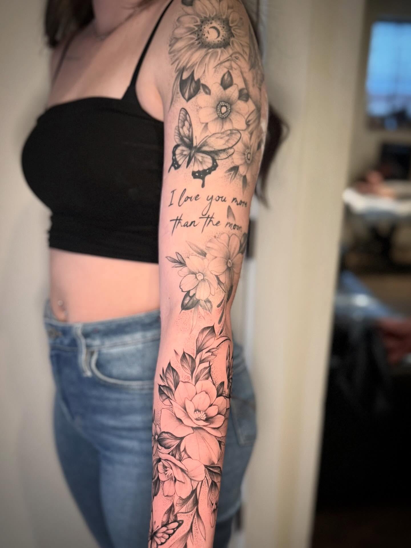 Flowers and butterfly black and grey tattoo on the forearm by Matthew Crawley