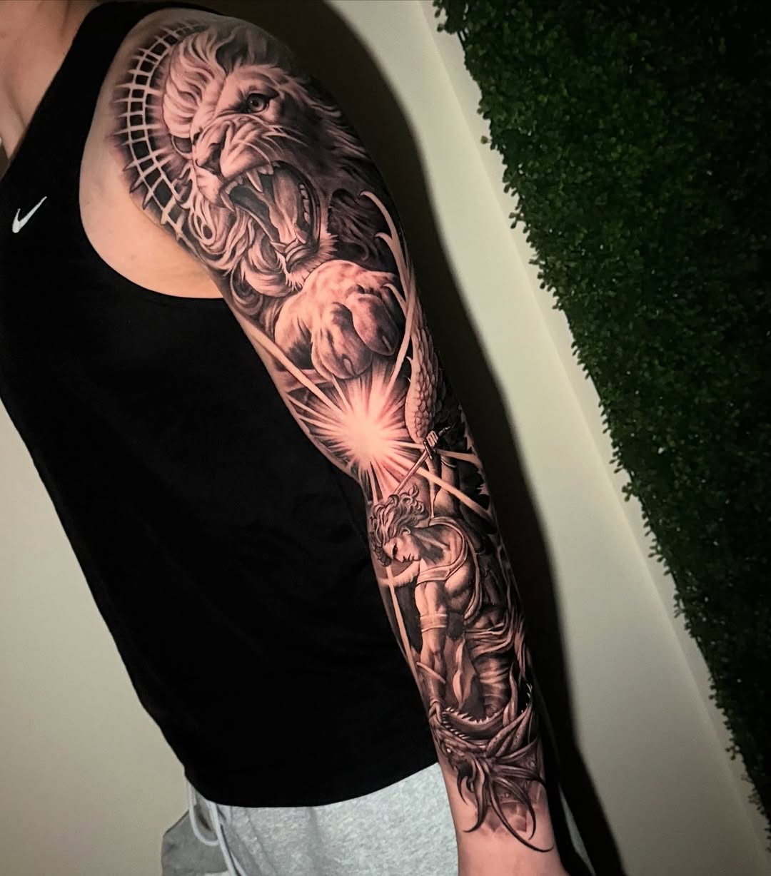 Lion and warrior fighting dragon realism tattoo on the forearm by Grace P