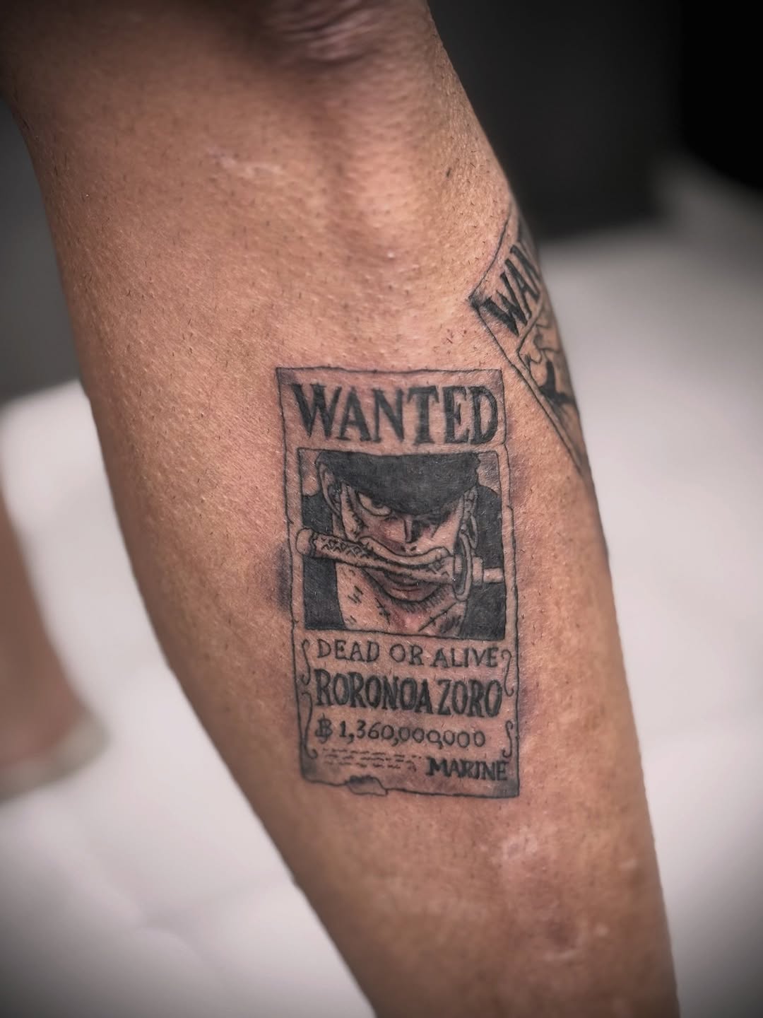 Roronoa Zoro wanted poster anime tattoo on the forearm by Mauricio gois