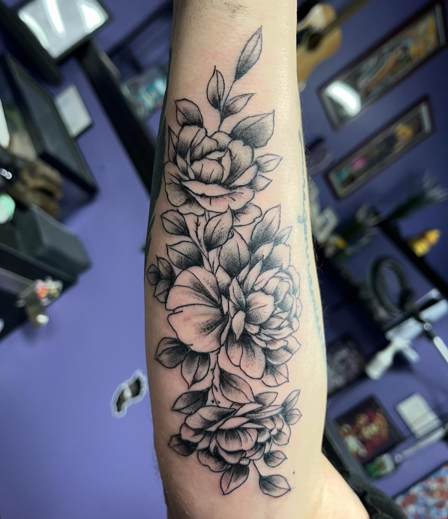 Flowers black and grey tattoo on the forearm by Mark Calloway