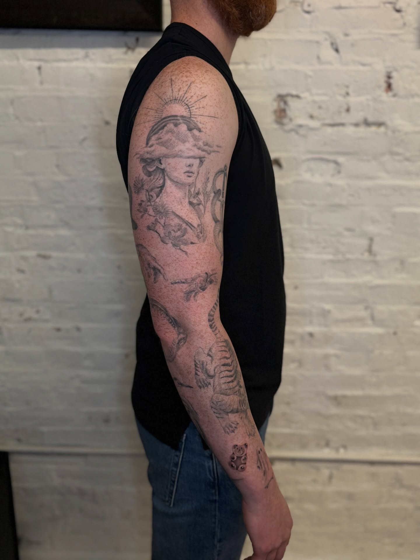 Woman with hat black and grey tattoo on the forearm by Josh Infante