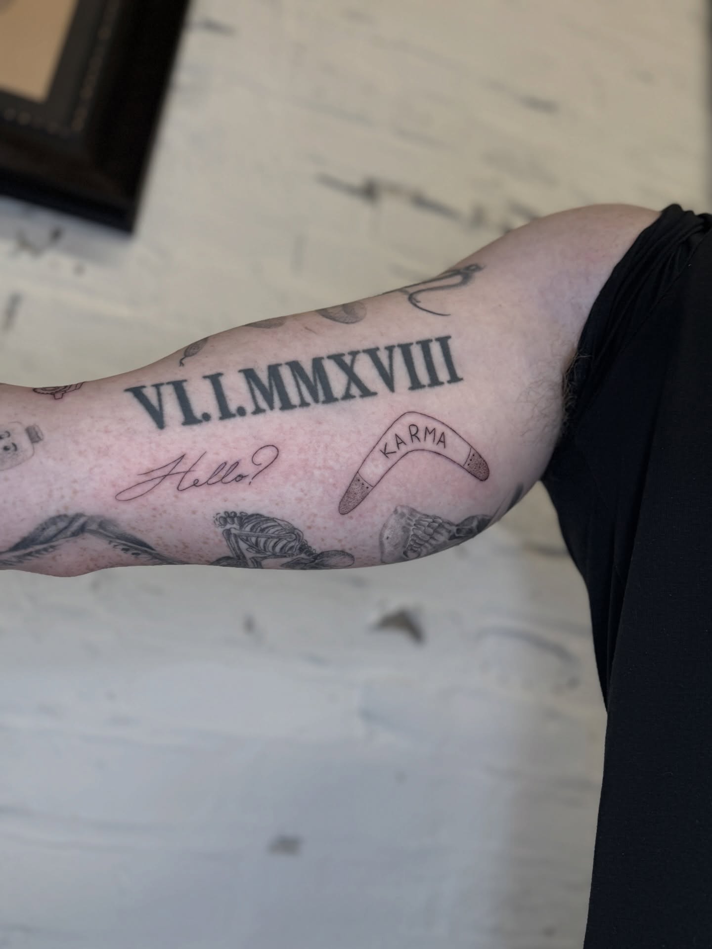 Roman numerals black and grey tattoo on the forearm by Josh Infante