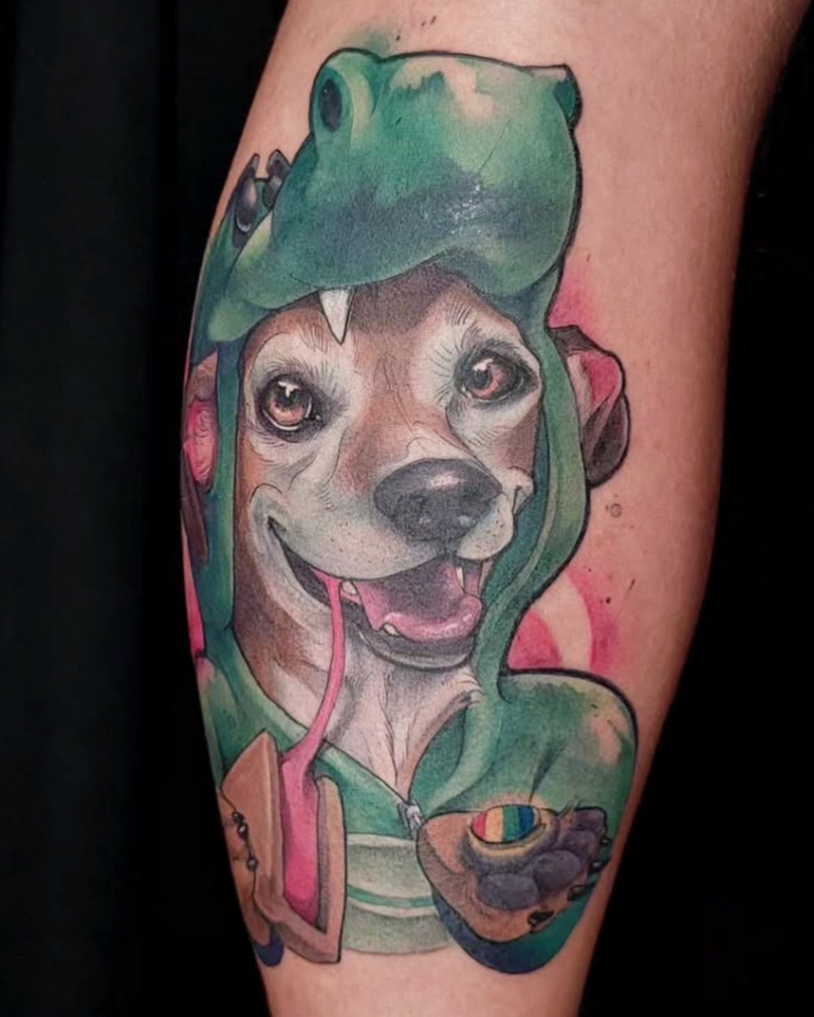 Dog wearing frog hat realism tattoo on the forearm by Jorell Elie