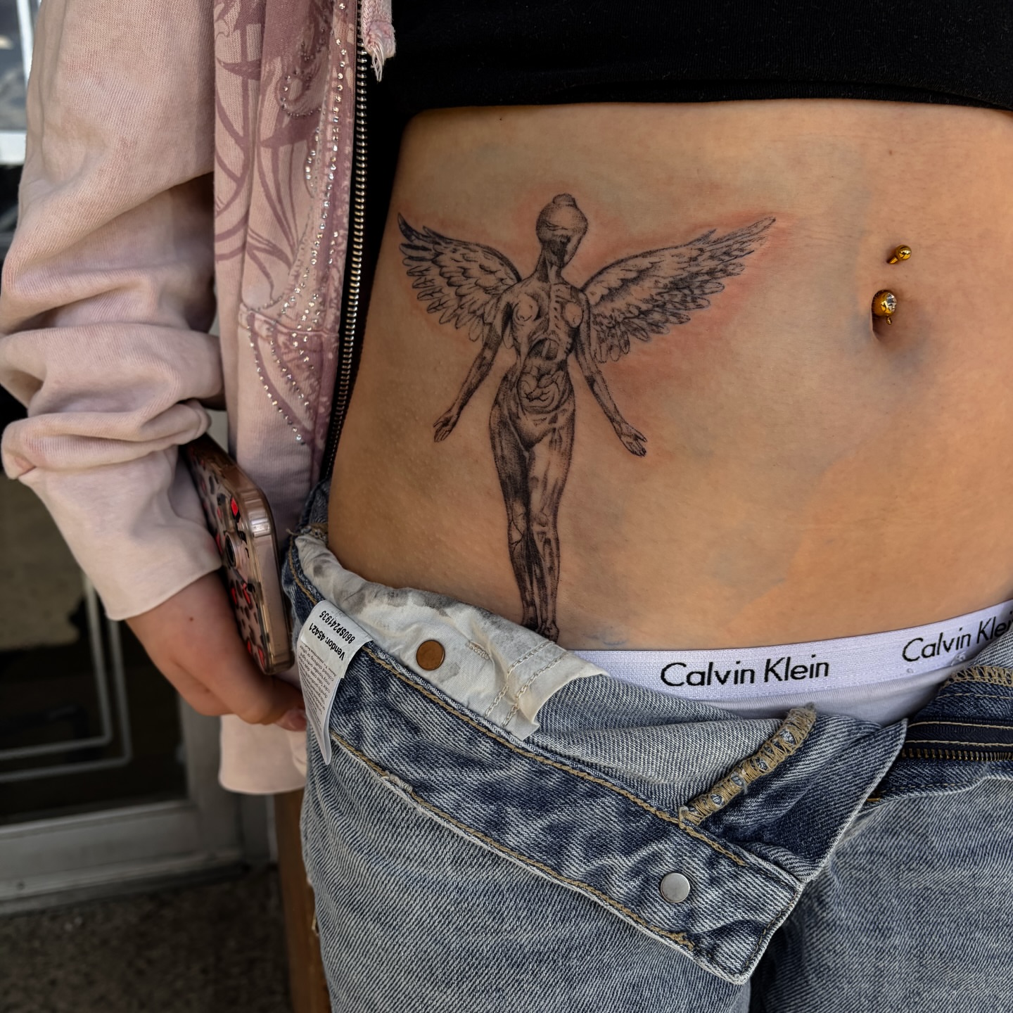 Winged figure black and grey tattoo on the torso by ⚜️Embodied Tattoo⚜️, Columbus, Ohio