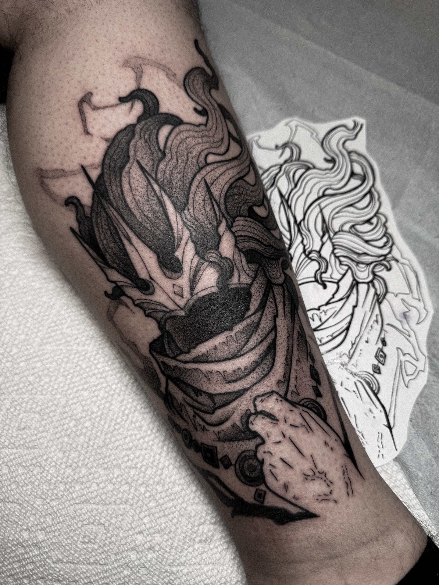 Flame and ribbon dotwork tattoo on the forearm by Dane Bezeau