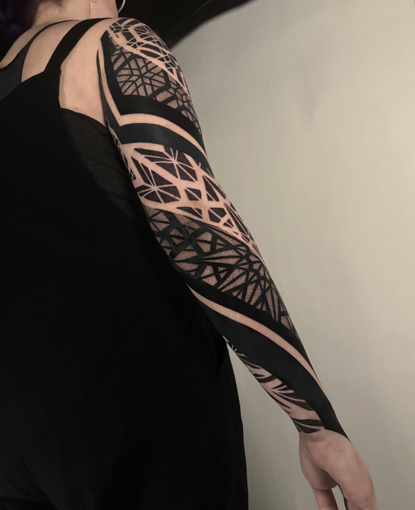 Geometric pattern geometric tattoo on the upper arm by Mitch Koch
