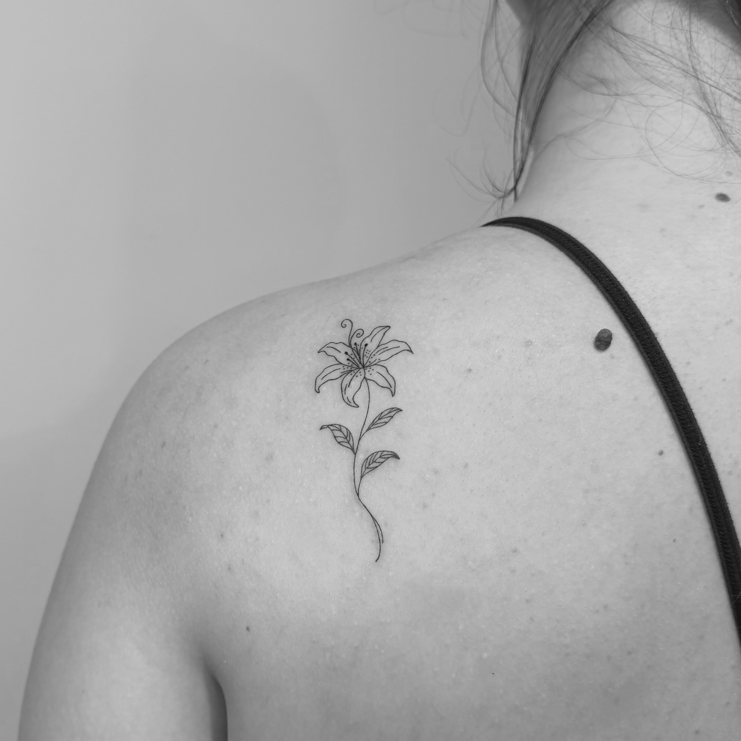 Lily black and grey tattoo on the shoulder by Jessica, Cheektowaga, New York