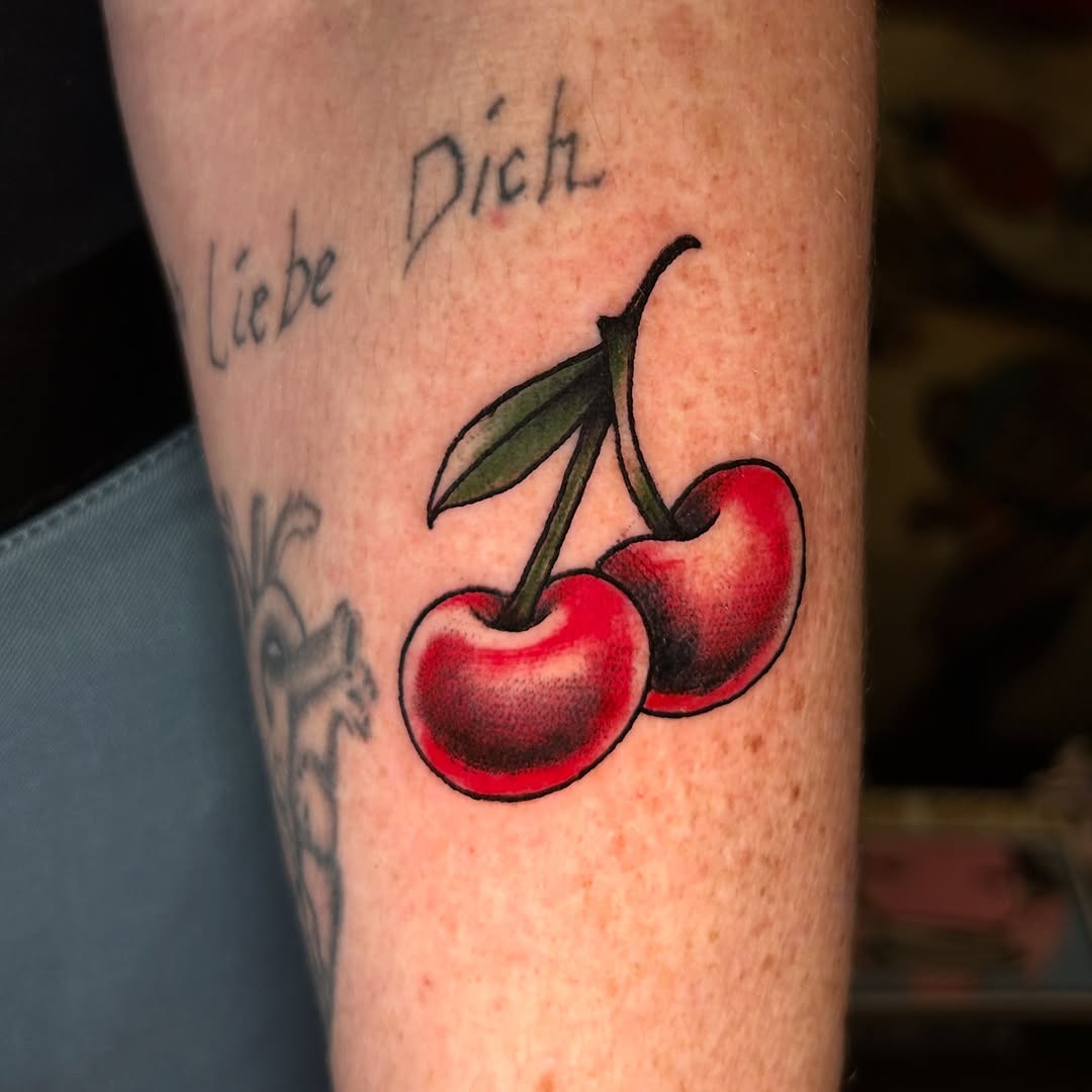 Cherries tattoo on the forearm by Olivia Marie