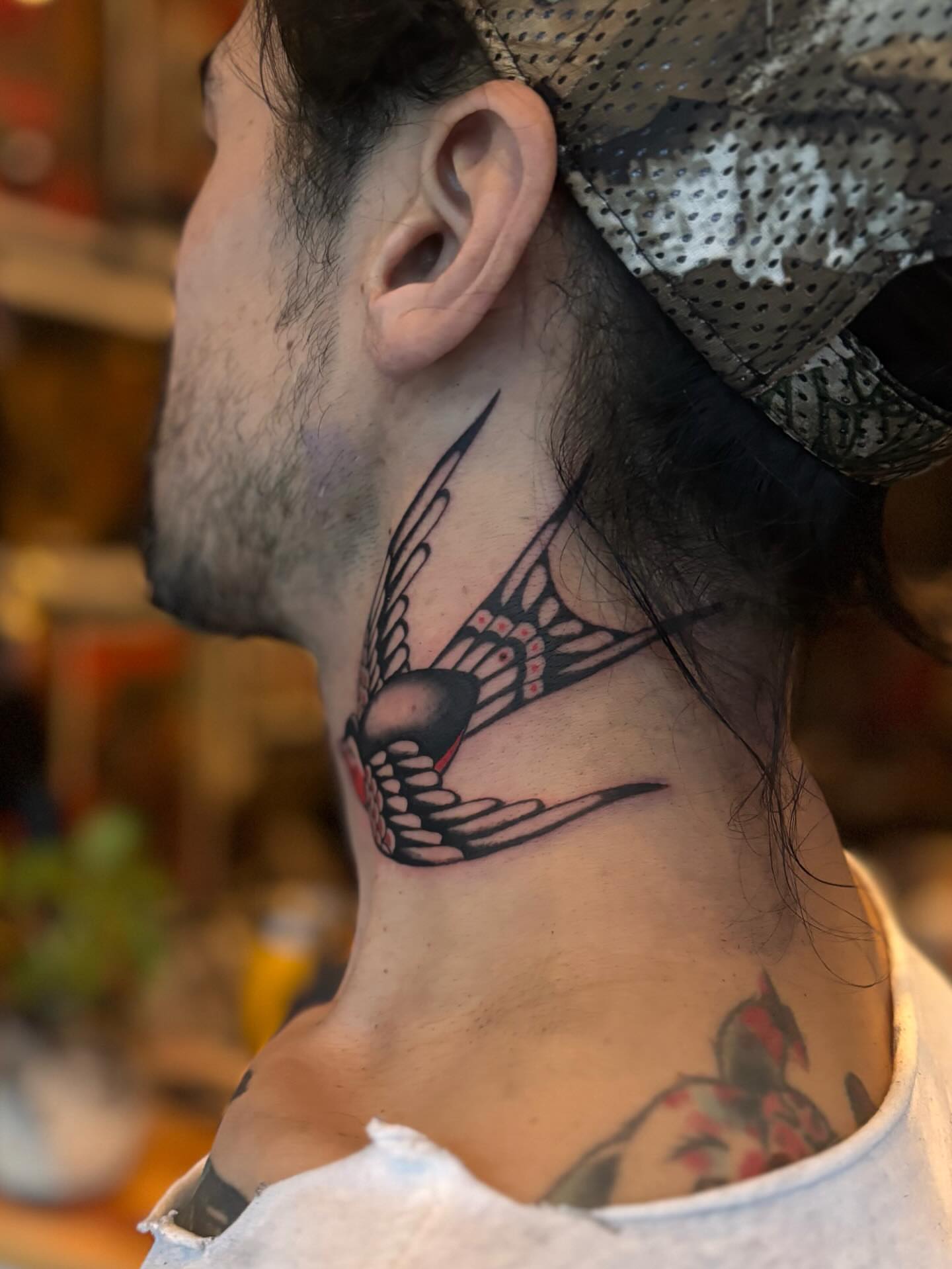 Swallow American traditional tattoo on the neck by Jesse Smith, Chicago, Illinois
