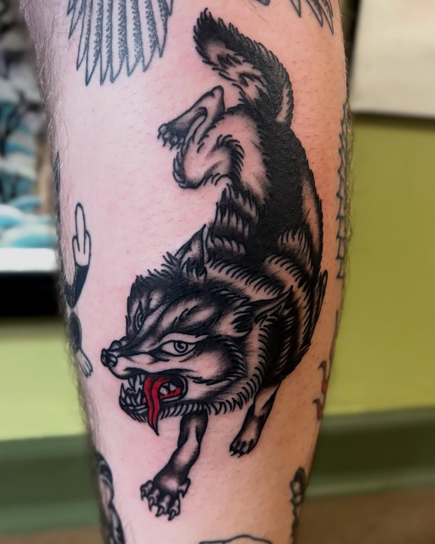 Wolf American traditional tattoo on the forearm by Tia Cave